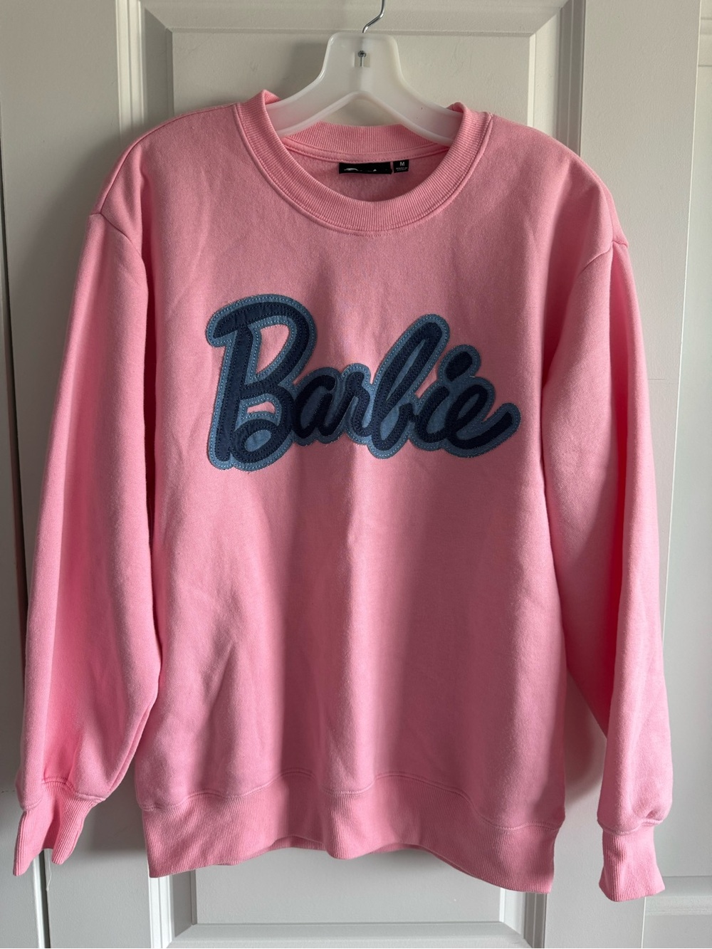 Barbie BoxLunch EXCLUSIVE faux denim logo crewneck sweatshirt in soft pink.